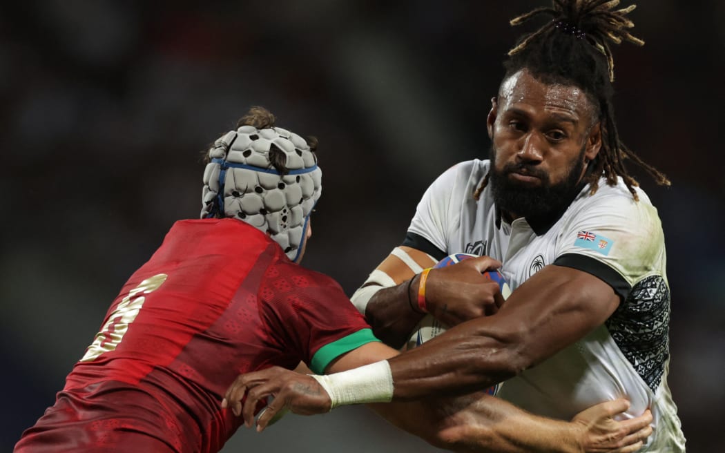 Fiji's outside centre and captain Waisea Nayacalevu (R) is tackled by Portugal's flanker David Wallis as he runs with the ball during the France 2023 Rugby World Cup Pool C match between Fiji and Portugal at the Stade de Toulouse in Toulouse, southwestern France on October 8, 2023. (Photo by Valentine CHAPUIS / AFP)