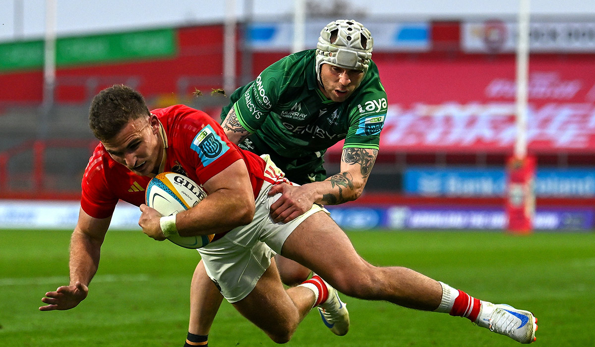 Shane Daly of Munster scores his side's fourth try despite the tackle of Mack Hansen of Connacht during the United Rugby Championship match between Munster and Connacht at Thomond Park in Limerick. Pic: Brendan Moran/Sportsfile