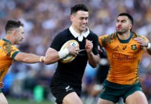 New Zealand's Will Jordan evades a tackle from Australia's Tom Wright and Nic White in their September 2024 Bledisloe Cup match in Sydney.