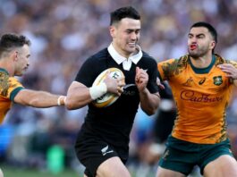 New Zealand's Will Jordan evades a tackle from Australia's Tom Wright and Nic White in their September 2024 Bledisloe Cup match in Sydney.