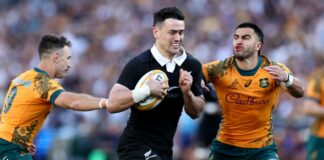 New Zealand's Will Jordan evades a tackle from Australia's Tom Wright and Nic White in their September 2024 Bledisloe Cup match in Sydney.