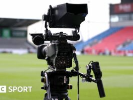 A TV camera pitchside at Sale Sharks' AJ Bell Stadium