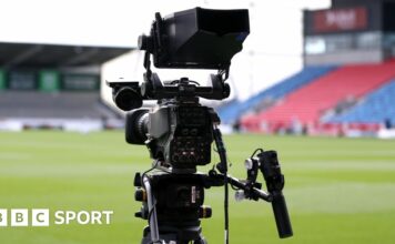 A TV camera pitchside at Sale Sharks' AJ Bell Stadium