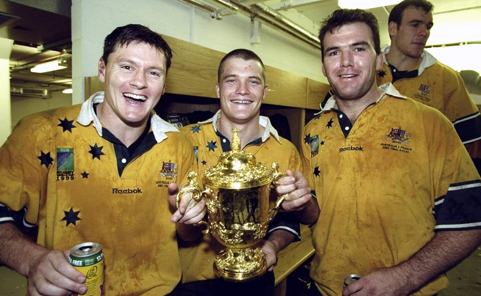 Matt Burke, Ben Tune and Owen Finegan with the Web Ellis trophy in 1999.