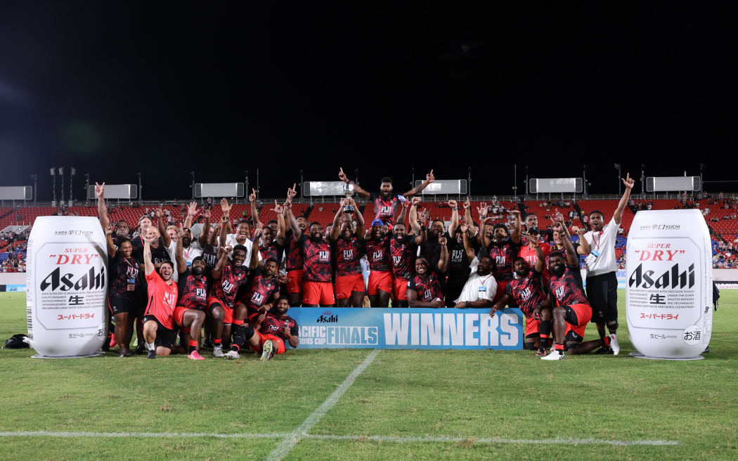 HIGASHIOSAKA, JAPAN - SEPTEMBER 21: Fiji players and staffs celebrate at the award ceremony after the team's 41-17 victory in the World Rugby Pacific Nations Cup Final between Fiji and Japan at Hanazono Rugby Stadium on September 21, 2024 in Higashiosaka, Osaka, Japan. (Photo by Paul Miller/Getty Images)