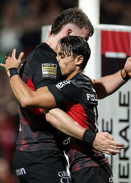 Toulouse's Italian wing Ange Capuozzo (R) celebrates his team's first try with Toulouse's French lock Joshua Brennan (L) during the French Top14 rugby union match between Stade Toulousain Rugby (Toulouse) and ASM Clermont Auvergne. Pic: Valentine CHAPUIS / AFP