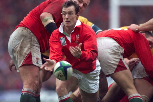 Wales scrum-half Rob Howley passes the ball.