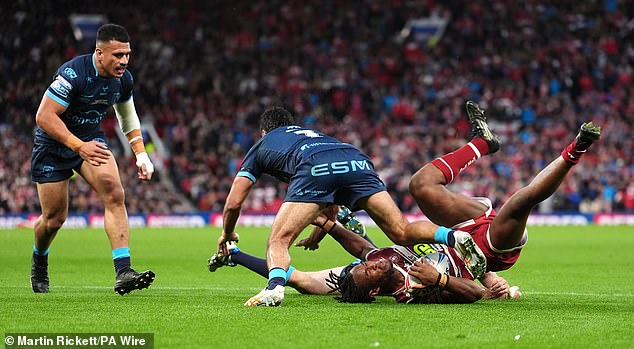 Peta Hiku (second from left) is facing a lengthy ban after being referred to the tribunal for touching the shoulder of Wigan's Junior Nsemba (with ball) after he was hurt in a big hit