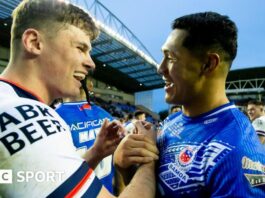 George Williams wrestles his way forward under pressure from the Samoa defence who are wrapping him up with tackles