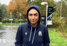 Emma Wassell, wearing a Scotland rugby hoodie, smiling at the camera