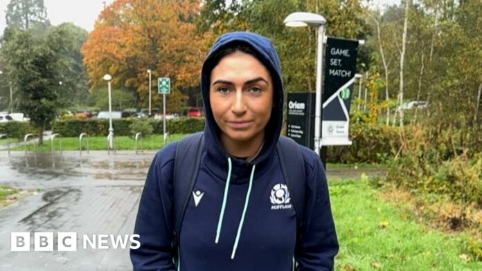 Emma Wassell, wearing a Scotland rugby hoodie, smiling at the camera