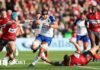 Josh Bayliss barges through a tackle with the ball