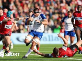 Josh Bayliss barges through a tackle with the ball