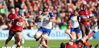 Josh Bayliss barges through a tackle with the ball