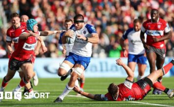 Josh Bayliss barges through a tackle with the ball