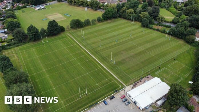 Drone picture showing four rugby pitches flanked by trees