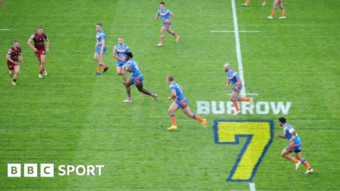 Headingley Stadium with a tribute to Rob Burrow on the pitch during a game