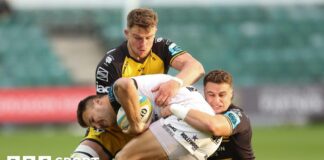 Andre Esterhuizen of Hollywoodbets Sharks is tackled by Harry Wilson of Dragons and Shane Lewis-Hughes of Dragons 