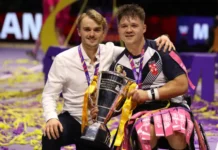 Tom Coyd, Head Coach of England and Tom Halliwell of England celebrate with the World Cup Trophy following the Wheelchair Rugby League World Cup Final match between France and England