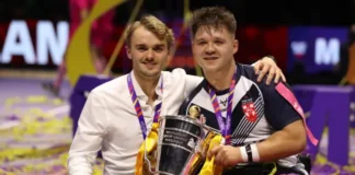 Tom Coyd, Head Coach of England and Tom Halliwell of England celebrate with the World Cup Trophy following the Wheelchair Rugby League World Cup Final match between France and England