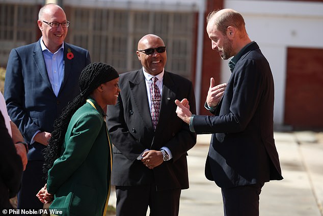 The Prince of Wales speaks with head girl Lyndel Musandida at Ocean View Secondary School