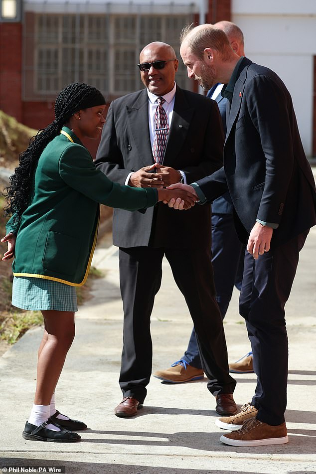 The Prince of Wales speaks with head girl Lyndel Musandida at Ocean View Secondary School