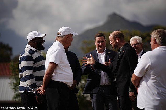 The Prince of Wales speaks with former Springboks player Tendai Mtawarira (left) today