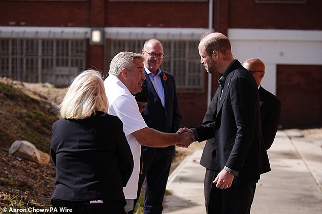 The Prince of Wales shakes hands with former England rugby player Jason Leonard today