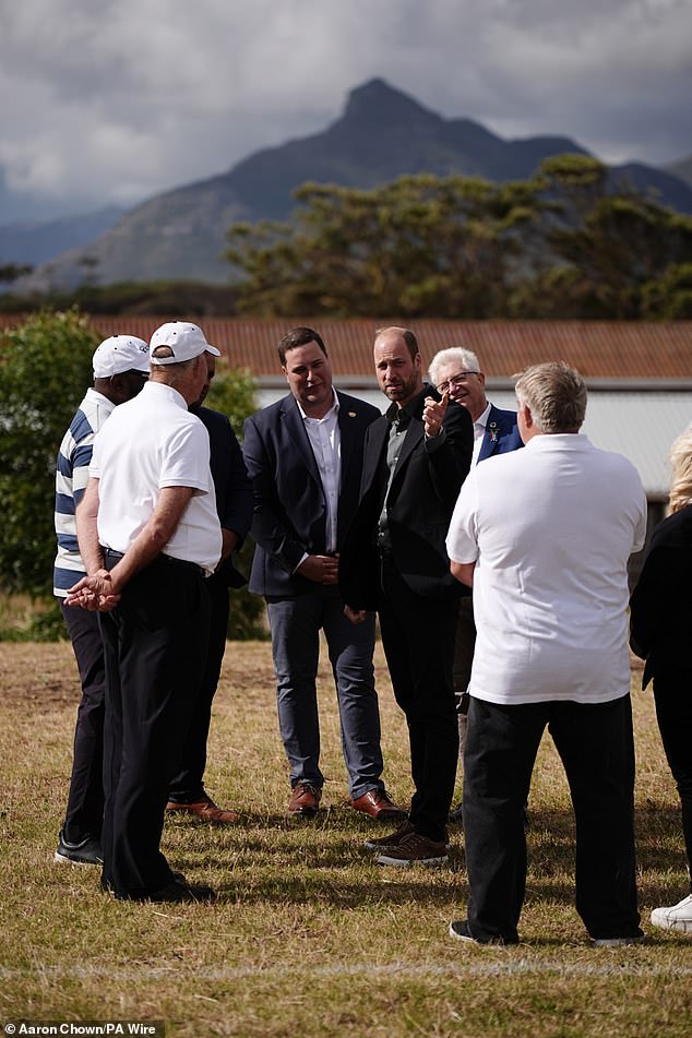 The Prince of Wales speaks with former Springboks player Tendai Mtawarira (left) today