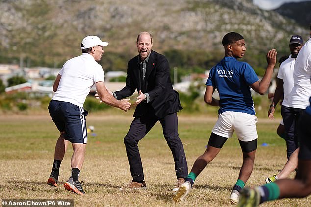 The Prince of Wales plays rugby with Joel Stransky today during the session in Cape Town