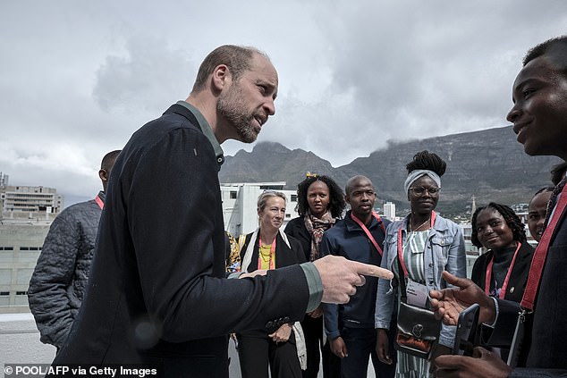 William speaks to a group of young people with Table Mountain in the background today