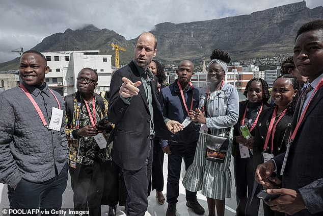 William speaks to a group of young people with Table Mountain in the background today