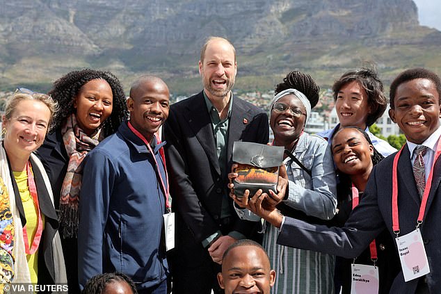 William poses with young climate activists in front of Table Mountain in Cape Town today