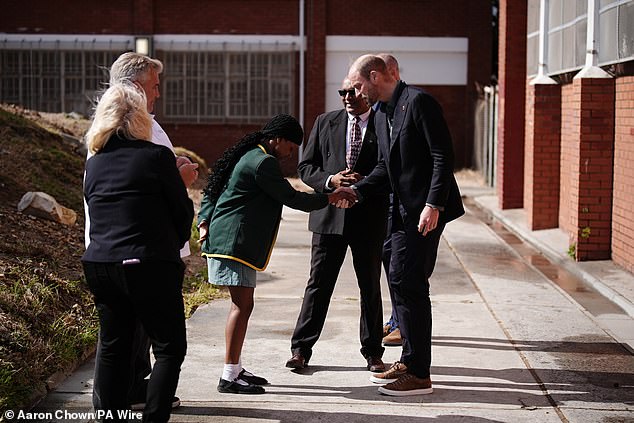 The Prince of Wales speaks with head girl Lyndel Musandida at Ocean View Secondary School