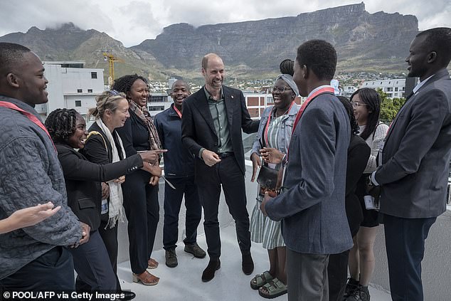 William speaks to a group of young people with Table Mountain in the background today