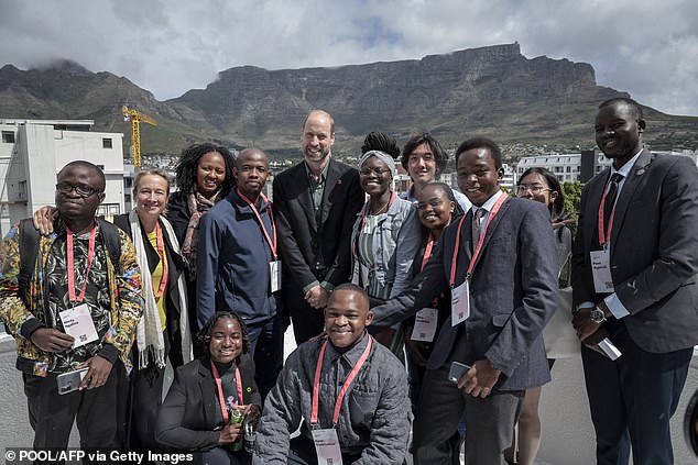 Prince William poses for a photo with a group of young people with Table Mountain in the background, at the Earthshot Prize Climate Leaders Youth Programme in Cape Town today