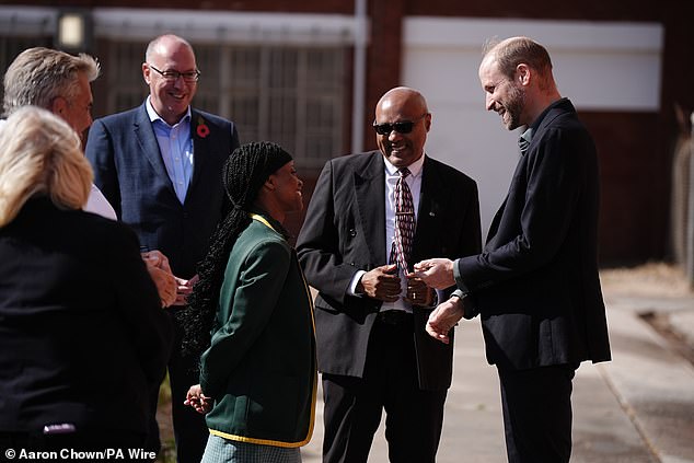 The Prince of Wales speaks with head girl Lyndel Musandida at Ocean View Secondary School