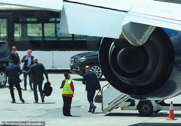 Prince William (centre) arrives at Cape Town Airport today for his four-day visit to South Africa