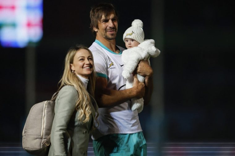 South Africa's lock Eben Etzebeth (C) carries his child as he walks next to his wife Anlia Etzebeth (L) after South Africa won the first Rugby Union test match between South Africa and Ireland at Loftus Versfeld stadium in Pretoria on July 6, 2024. (Photo by PHILL MAGAKOE / AFP) (Photo by PHILL MAGAKOE/AFP via Getty Images)