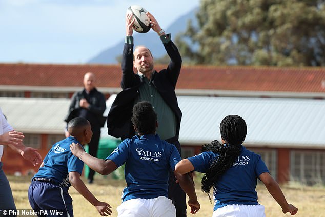 The prince jumps to catch the ball during his visit to Ocean View Secondary School