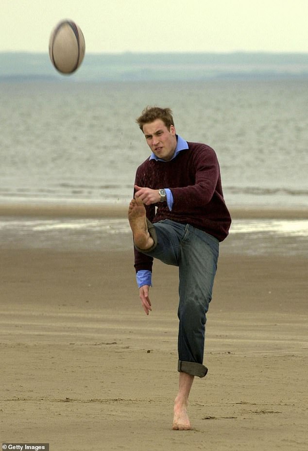 The prince kicks a rugby ball barefoot on the beach at St Andrews in 2003