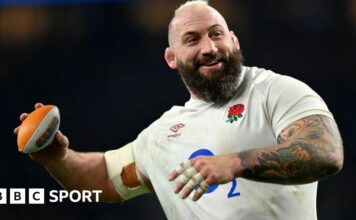 Joe Marler throwing a mini rugby ball.