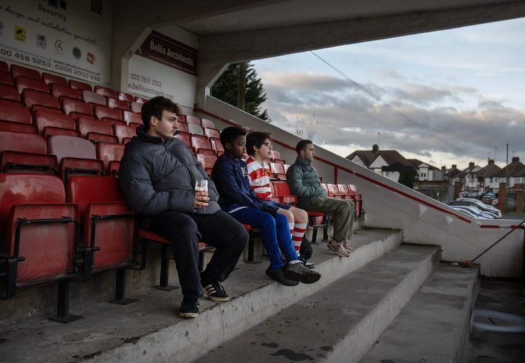 Youth players watch from the stand as Finchley RFC play a Saturday afternoon match against Ealing Trailfinders. A close match in which the hosts Finchley lost 24-26. [ Verbal consent was given but was a bit confusing as to who's father gave it. ]14/12/24. Photo Tom Pilston