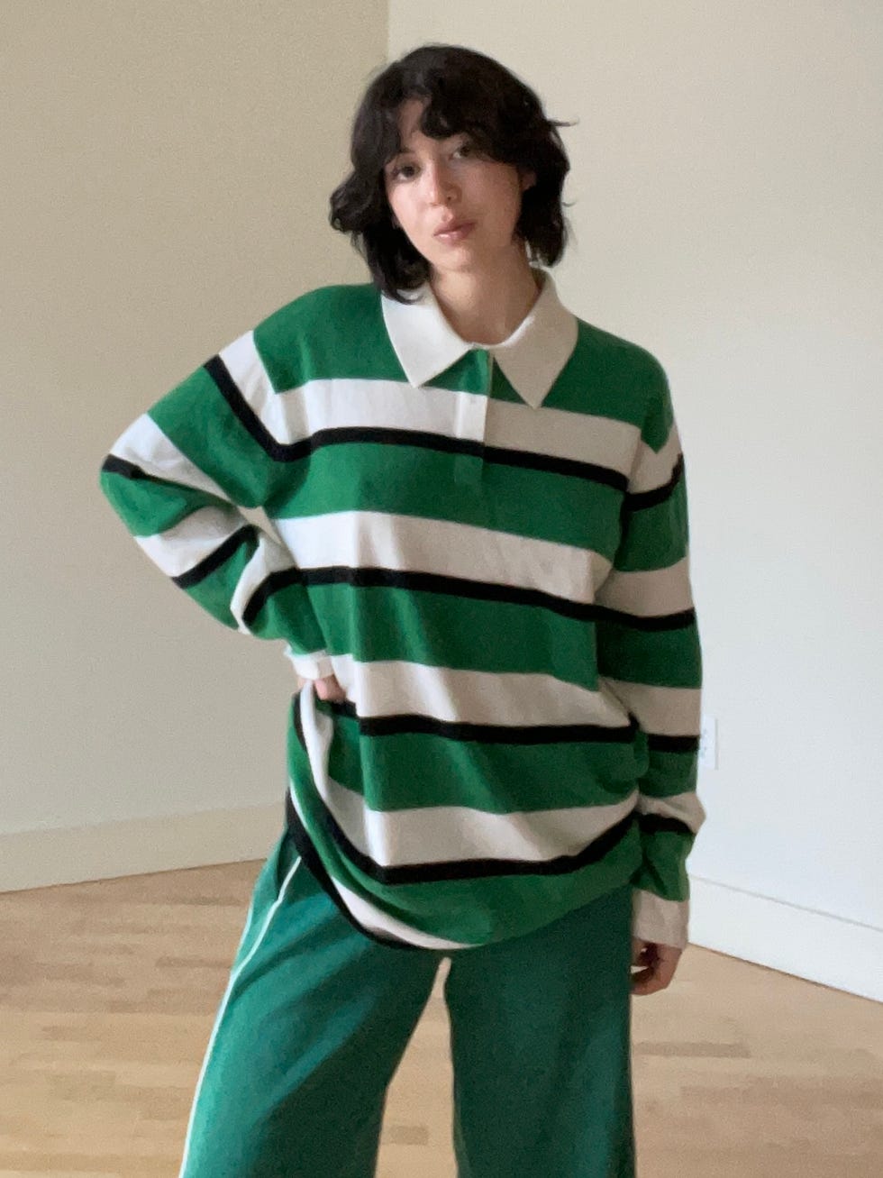 individual wearing a green and white striped sweater with black stripes and green pants