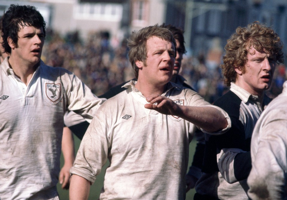 Geoff Wheel (centre) of Swansea during a match against the Barbarians