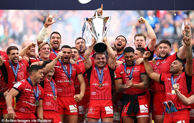 Antoine Dupont holds aloft the Champions Cup trophy after Toulouse's win over Leinster