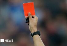 A red card is held up (stock image).