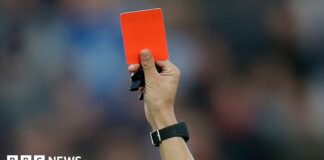 A red card is held up (stock image).