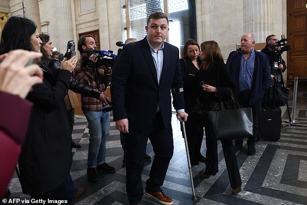 Irish rugby player Denis Coulson (C), who is accused of gang rape, talks with his lawyer Corinne Dreyfus-Schmidt (3R) before his trial at the Bordeaux courthouse, in Bordeaux south-western France, on December 2, 2024