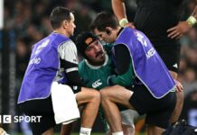 Tom O'Toole is treated by medical staff 